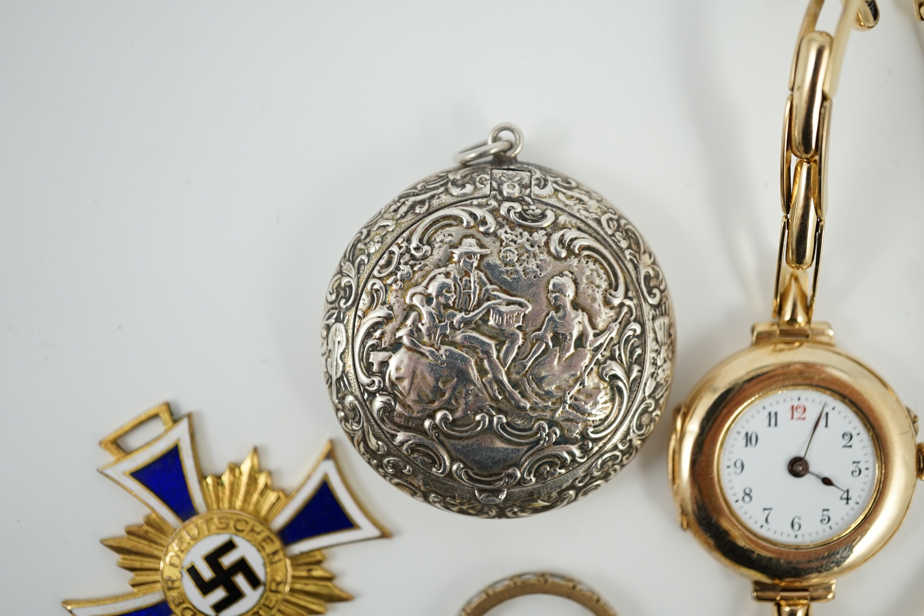 An early 20th century 9ct gold manual wind wrist watch, on a 15ct expanding bracelet, case diameter 28mm, gross weight 25.3 grams, a yellow metal and simulated diamond set eternity ring, A 1930's German git and enamel cr